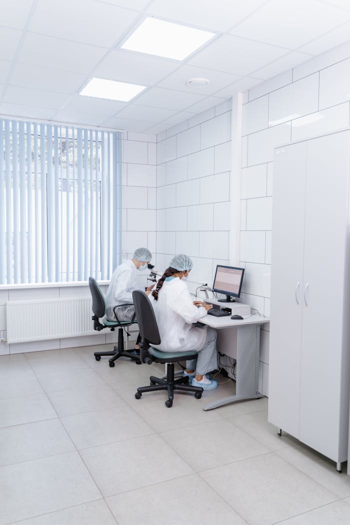 Two scientists working in a well-equipped lab, focusing on research and analysis.